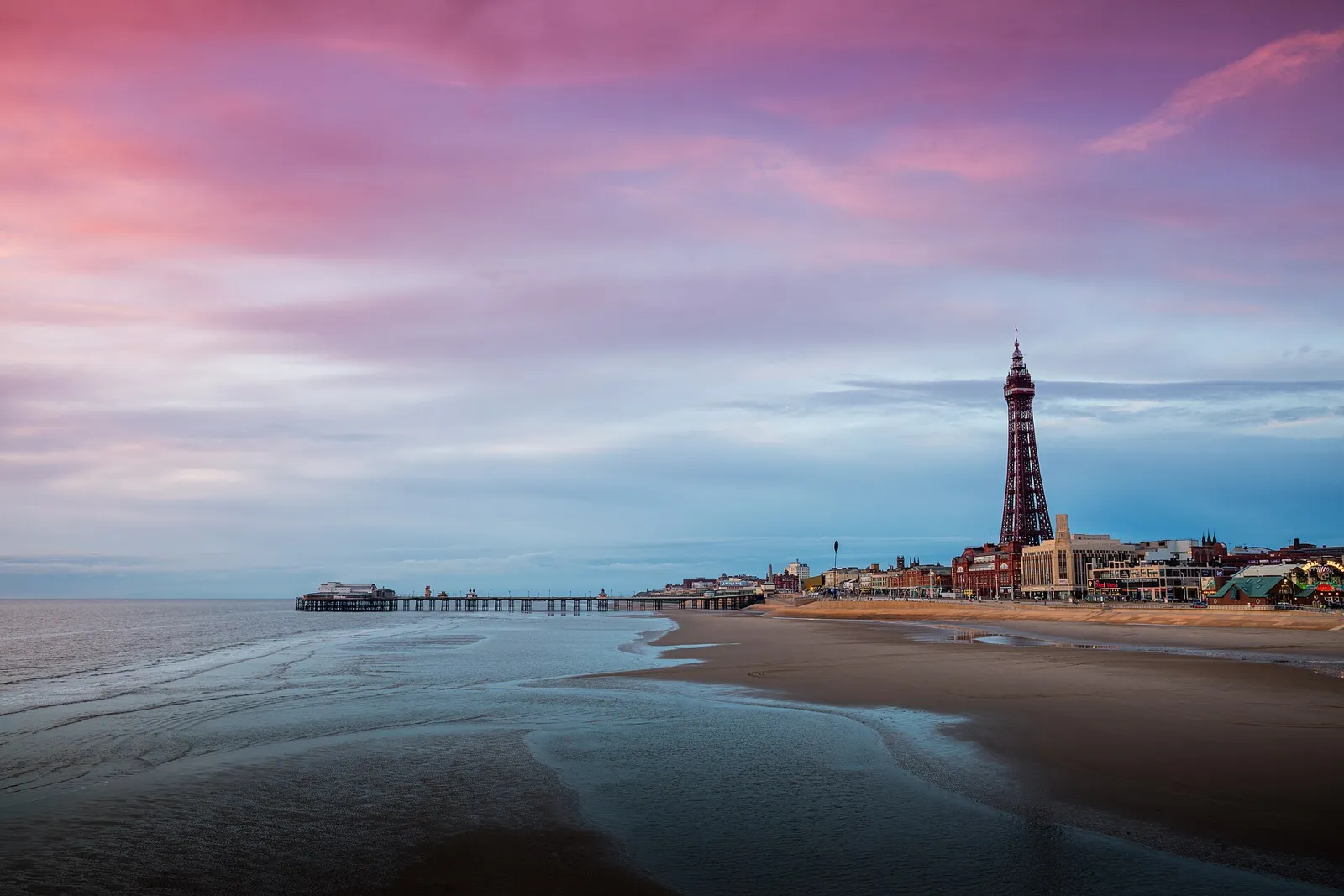 Central Pier and Blackpool Tower under a pink evening sky