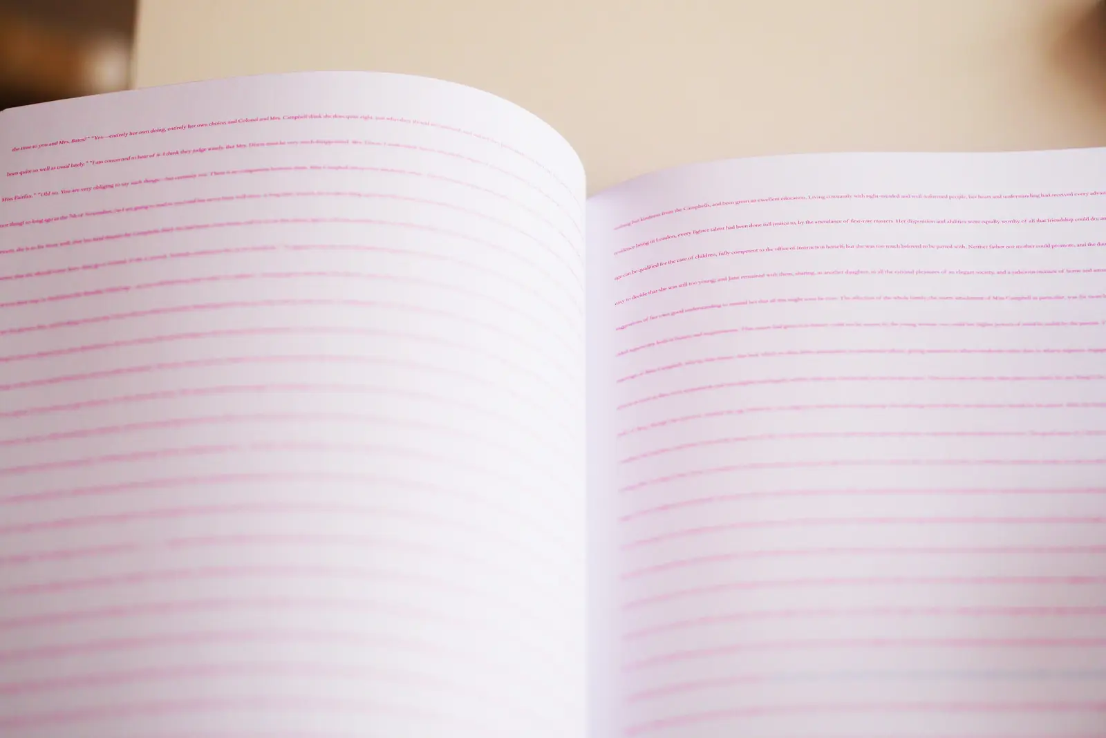 An open notebook with pink ruled lines
