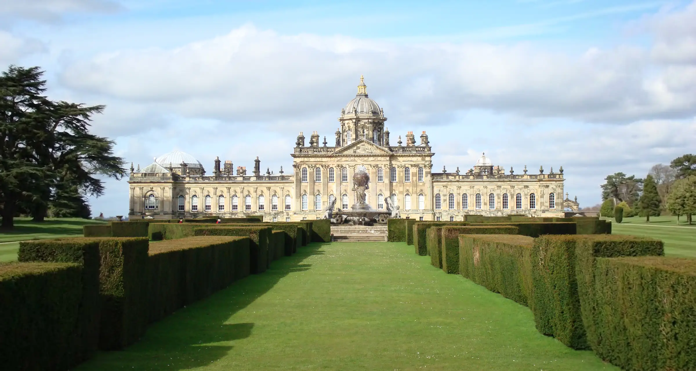 Castle Howard in North Yorkshire, seen along a hedged lawn